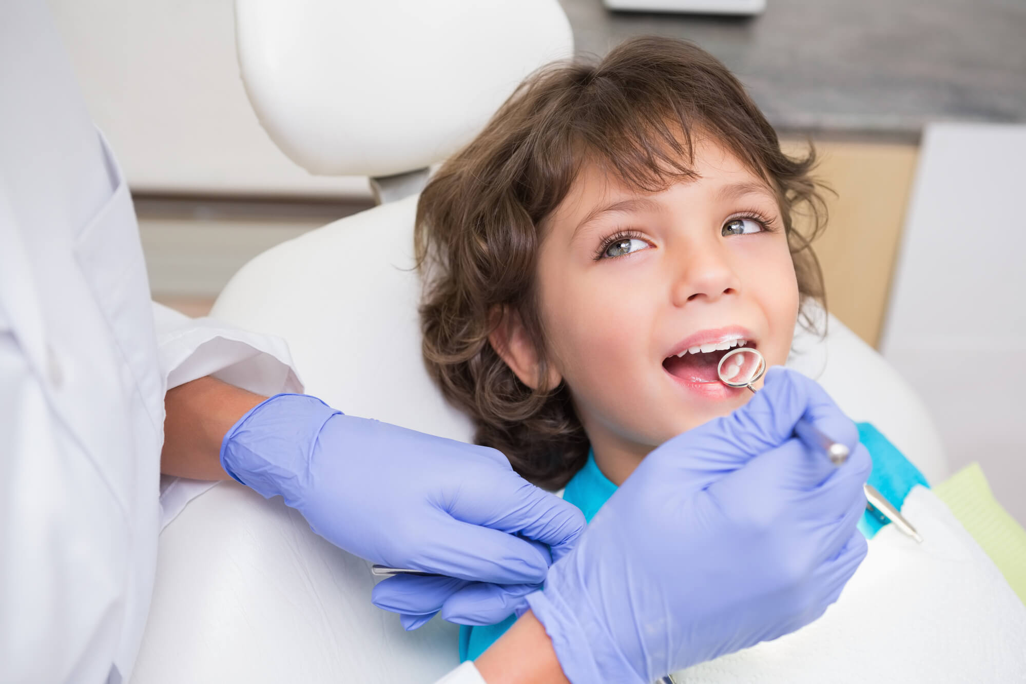 A pediatric dentist in South Miami examines a patient's teeth